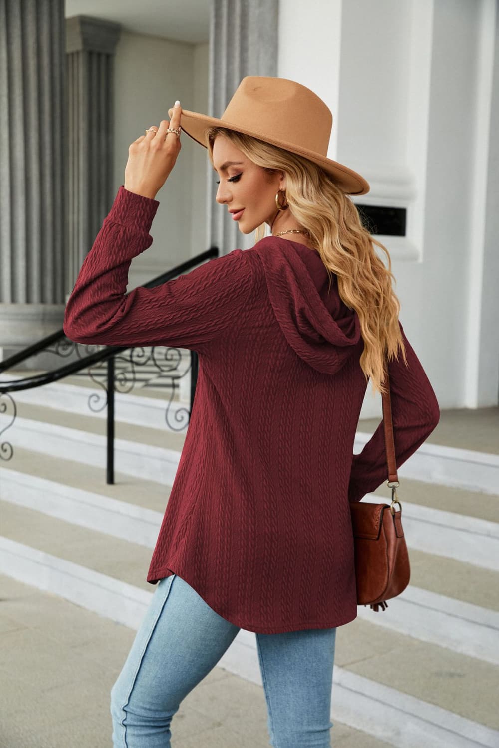 Textured henley hooded tunic in wine with long sleeves and a curved hem.