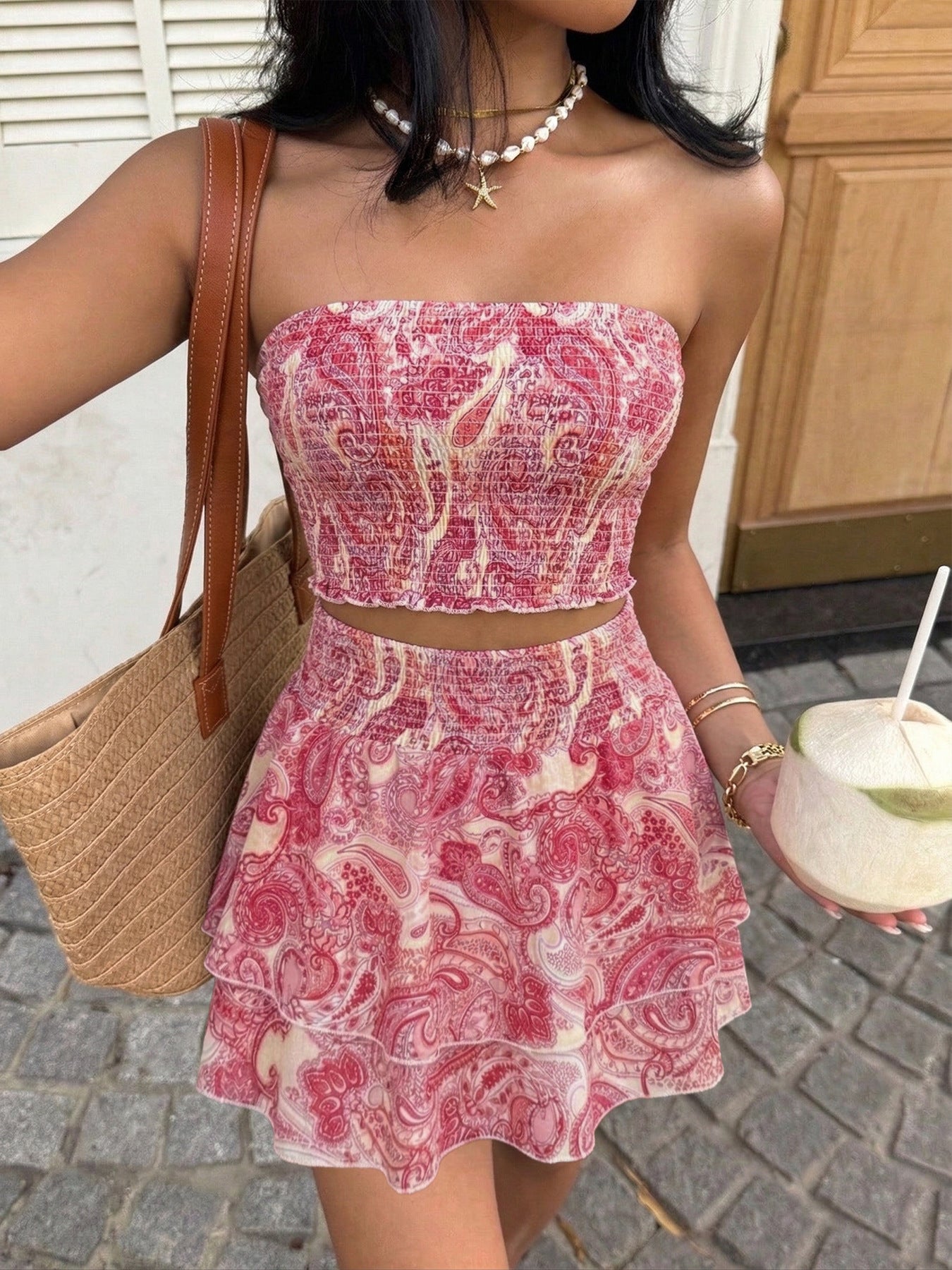 Paisley print smocked two-piece set with a strapless crop top and tiered frill skirt.