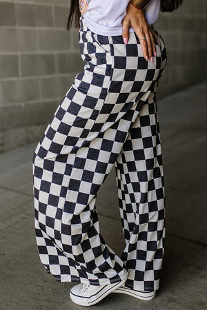 Checkerboard palazzo trousers in black and white, featuring a wide leg and casual styling.