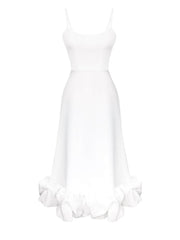 White midi dress with spaghetti straps and a ruffled hem detail.