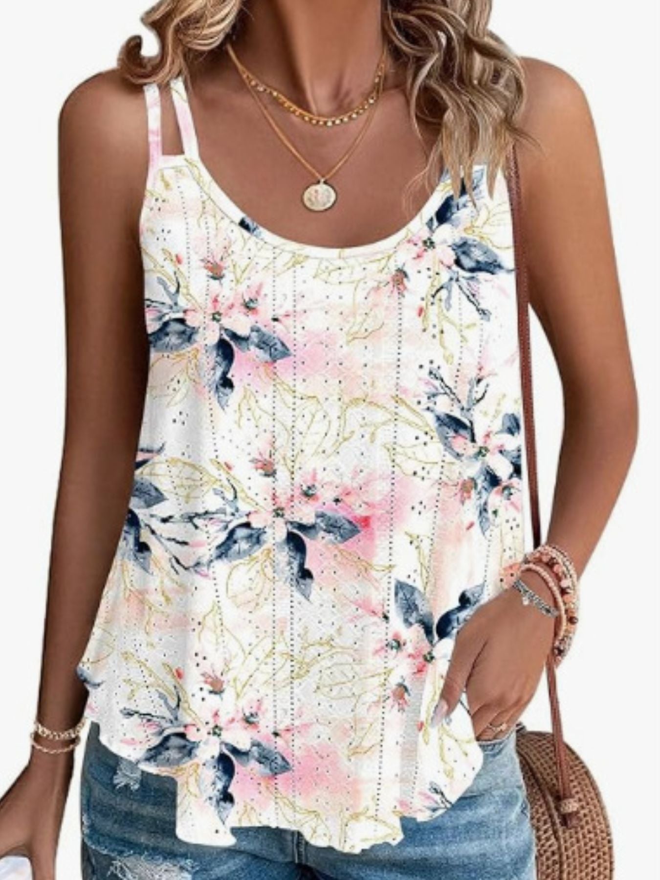 Floral eyelet cami with double straps and a scoop neck in white with pink and blue floral print.