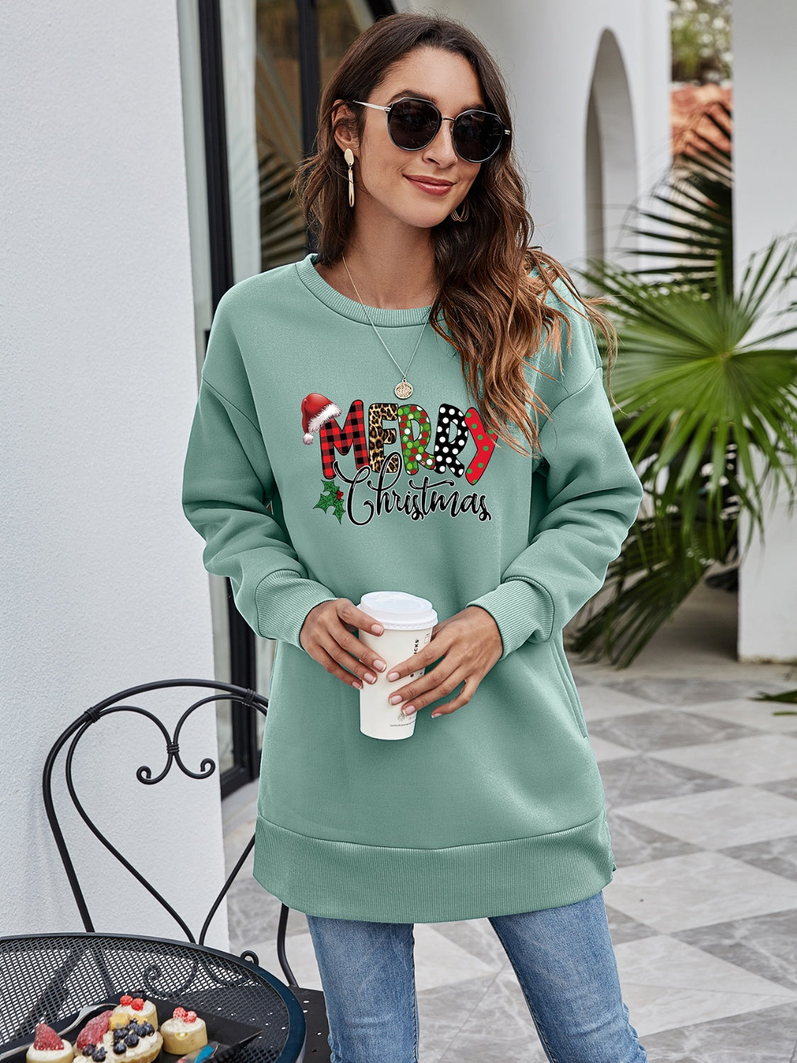 Sage green tunic sweatshirt with festive Merry Christmas graphic, crew neck, long sleeves.