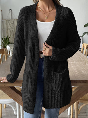 Black textured bouclé open-front cardigan with pockets and long sleeves.