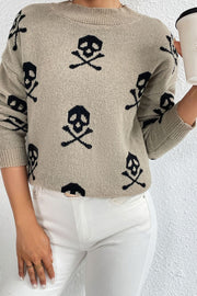 Khaki knit mock neck sweater with allover black skull and crossbones motif.