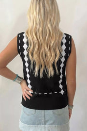 Black mock neck sweater vest with white diamond pattern and dashed line detail.