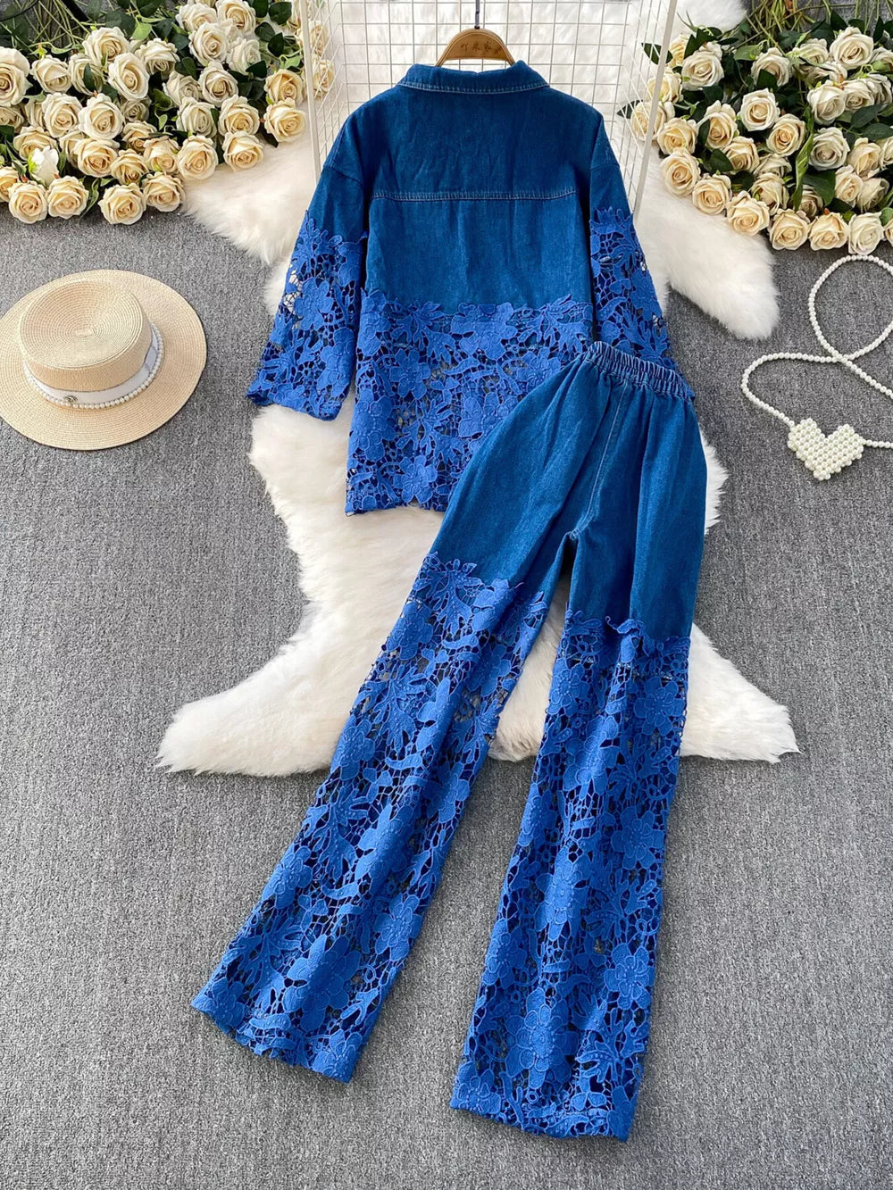 Blue two-piece denim set with lace sleeves and pant legs, collared button-up jacket