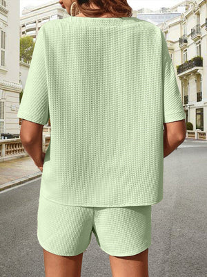 Light green waffle knit drawstring co-ord set with short sleeves and shorts.