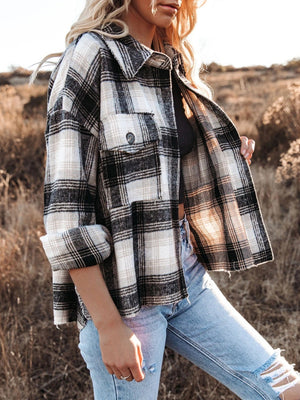 Plaid pocket long sleeve shirt jacket in black and white, open with rolled sleeves.