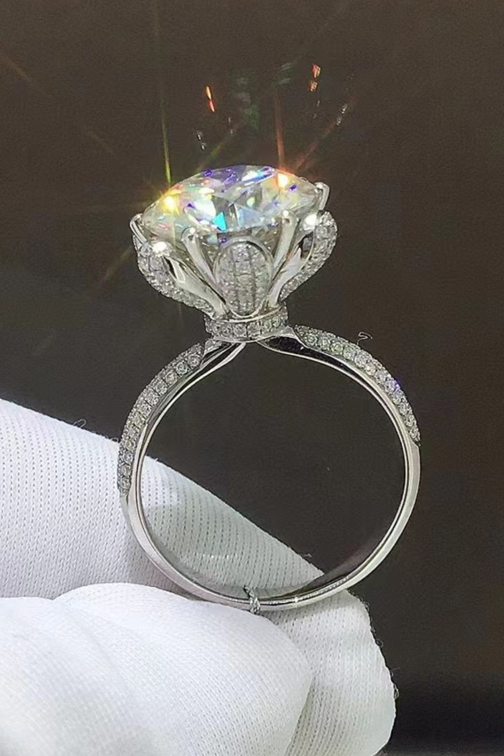 Sparkling Aura Moissanite Ring in silver with a large center stone and diamond-accented band.