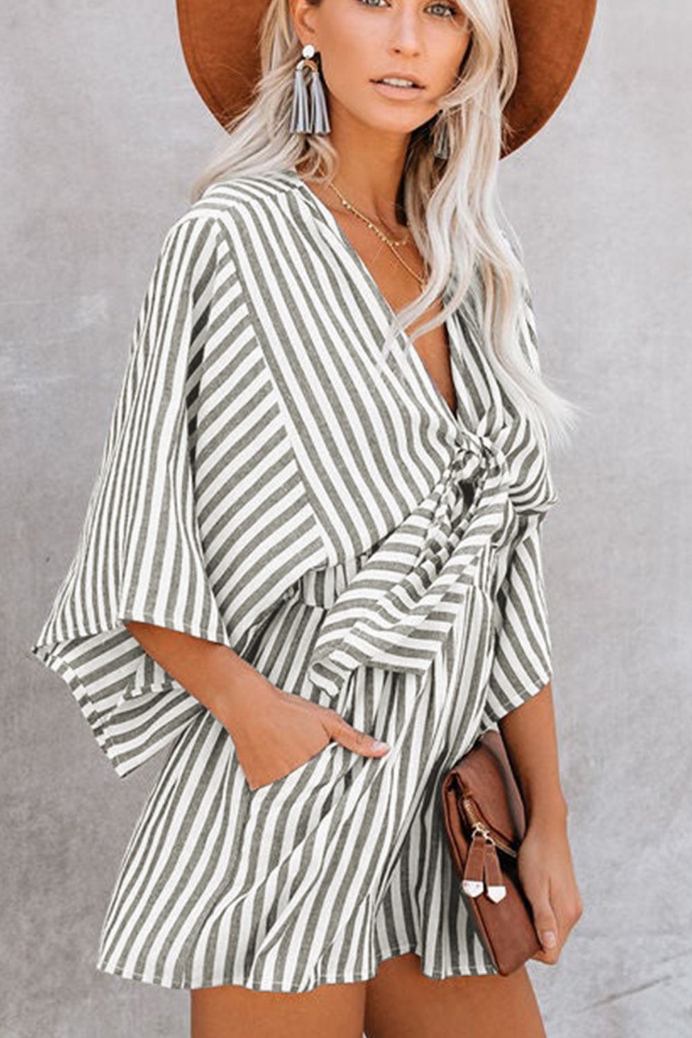 Striped tie-front kimono jumpsuit in dark gray with wide sleeves and pockets.