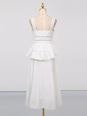 White eyelet embroidered midi dress with tiered ruffle skirt and cutout waist detail.