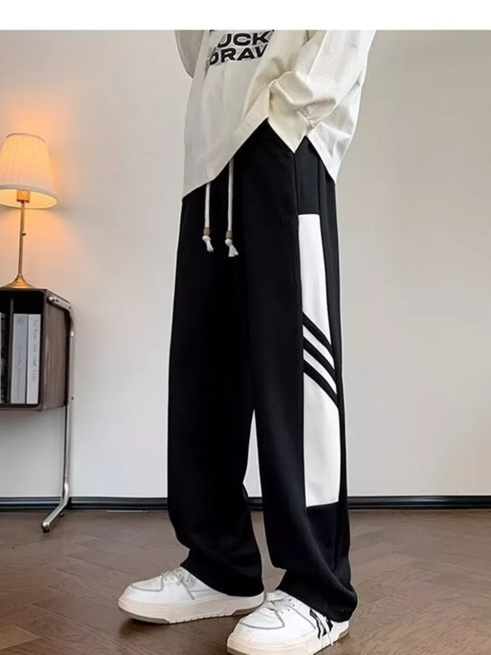Men's black sweatpants with white contrast stripe detail and drawstring waist