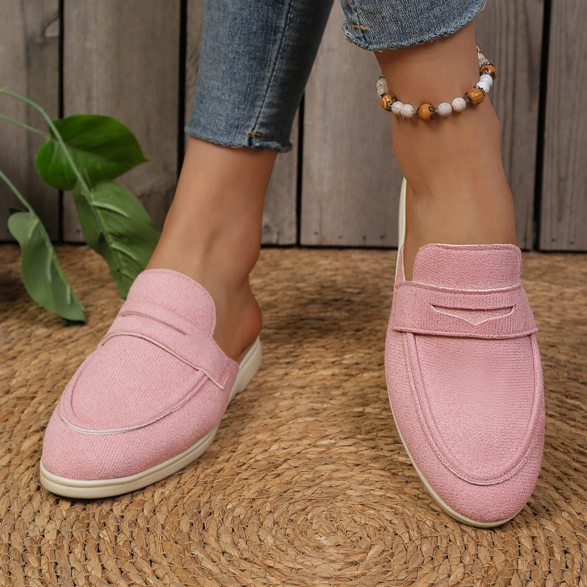 Pink textured round toe slip-on loafers with a backless design.