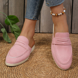 Pink textured round toe slip-on loafers with a backless design.