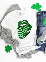 White graphic t-shirt with green glitter lips sticking out a tongue covered in shamrocks.