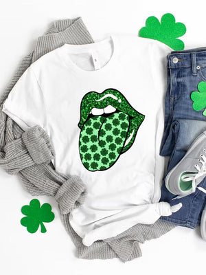 White graphic t-shirt with green glitter lips sticking out a tongue covered in shamrocks.