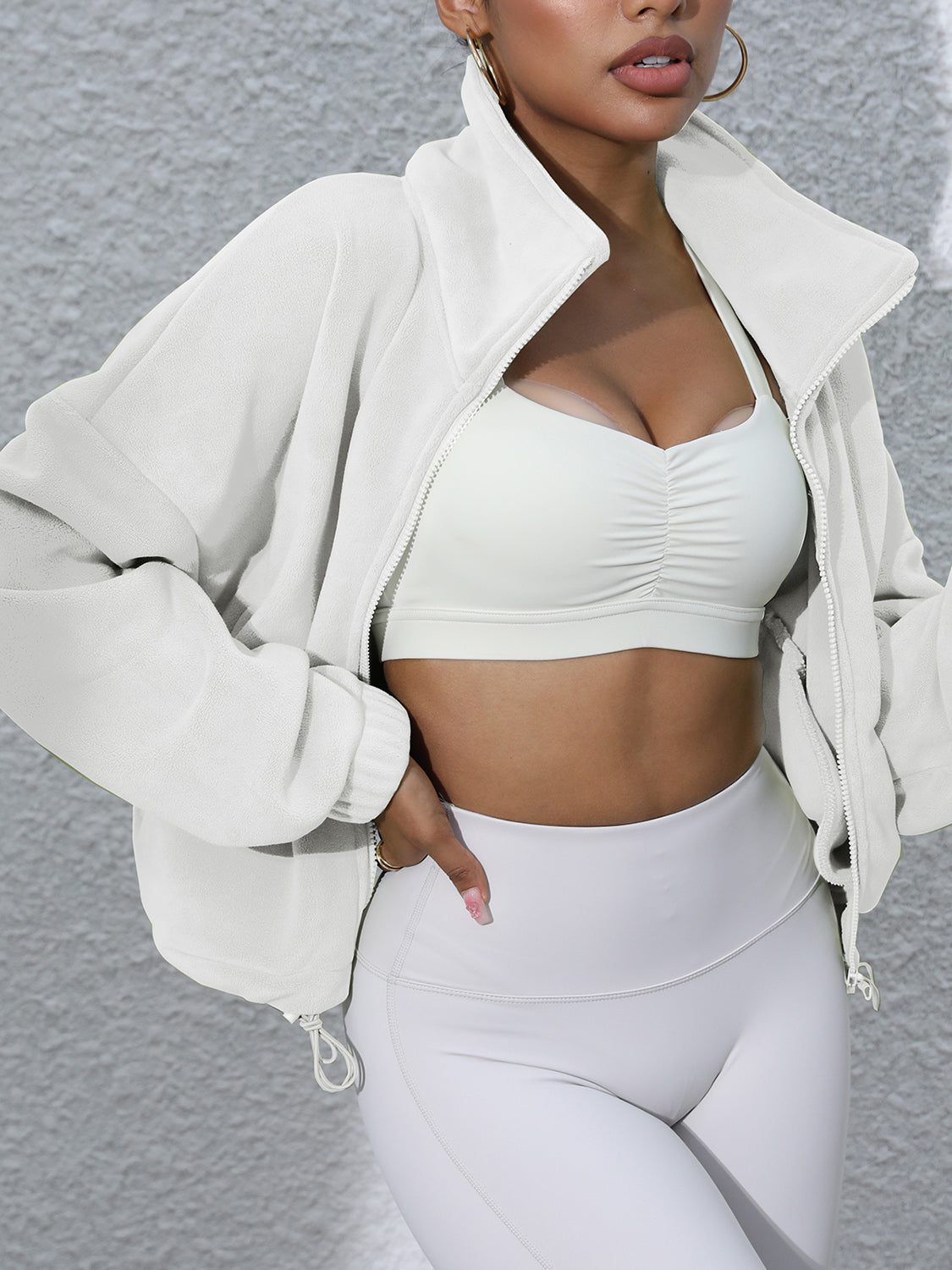White fleece cropped funnel neck jacket with zipper and drawstring hem detail.