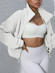 White fleece cropped funnel neck jacket with zipper and drawstring hem detail.