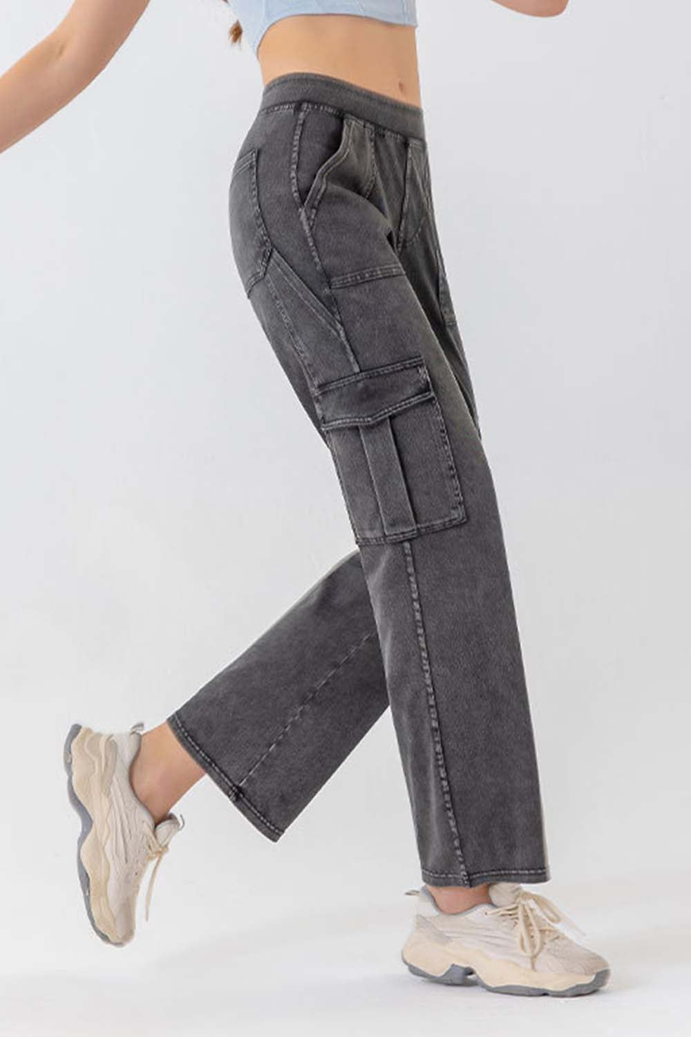 Gray denim cargo pants with utility pockets and a relaxed fit.