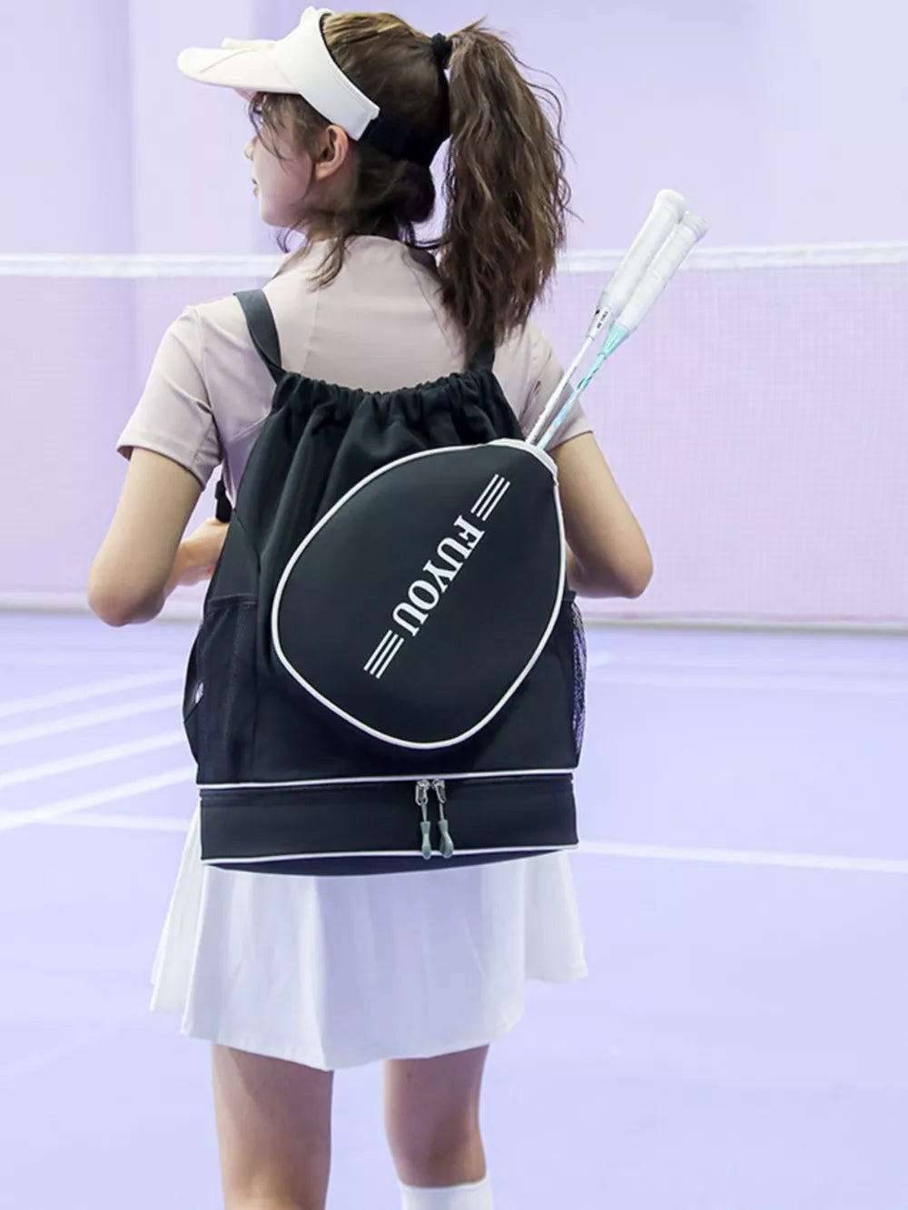 Black drawstring backpack with racket compartment and white trim, holding two rackets.