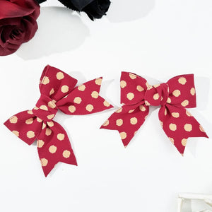 Deep red polka dot bow barrettes, a 2-piece set for adults.