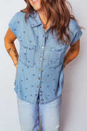 Light blue denim shirt with all-over dark stars, button front, short sleeves, and two chest pockets.