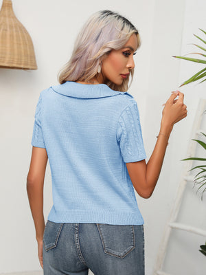Light blue cable knit polo top with short sleeves and a collared neckline.