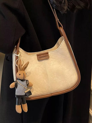 Off-white pu leather shoulder bag with brown piping and bunny charm