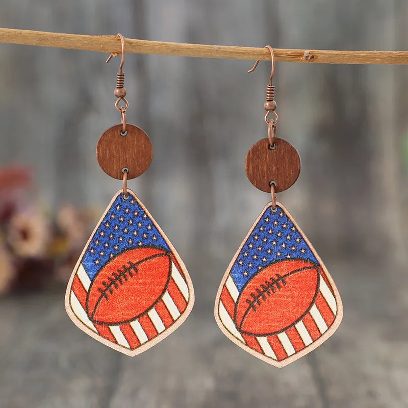 Patriotic football woodcut dangle earrings with American flag design.