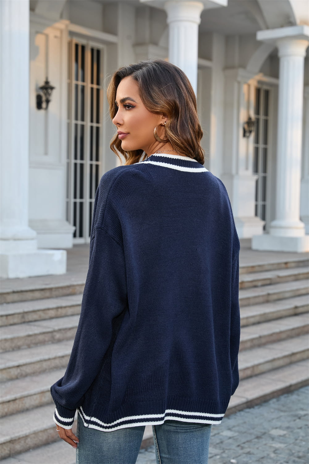Dark blue acrylic oversized knit cardigan with white contrast trim at neckline and cuffs