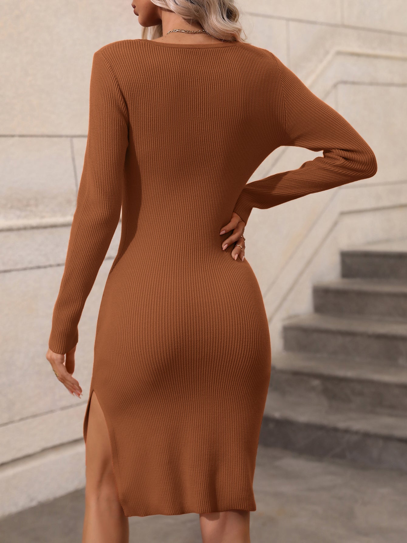 Brown ribbed midi dress with long sleeves and a high slit.