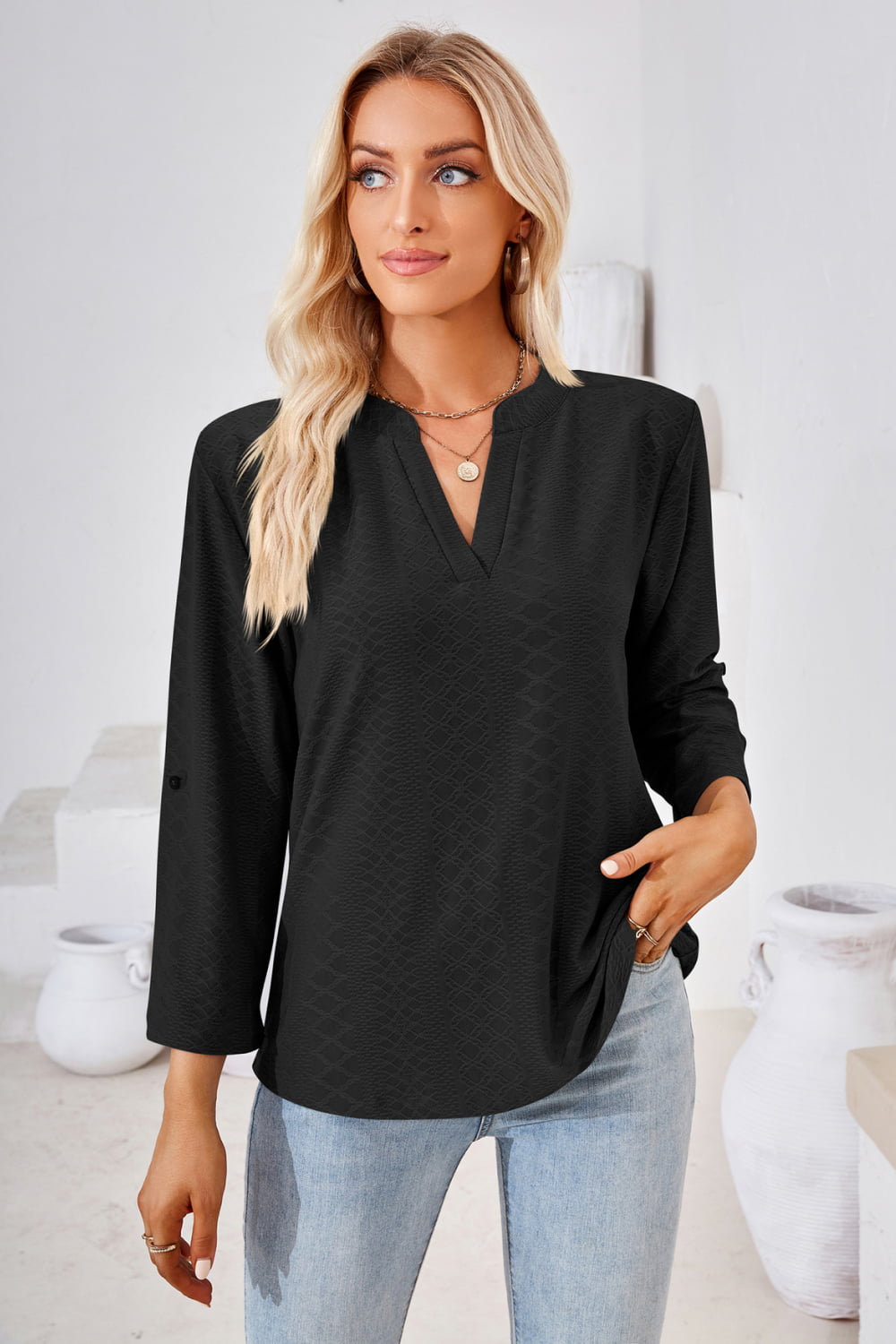 Black textured henley blouse with v-neck and rolled sleeves