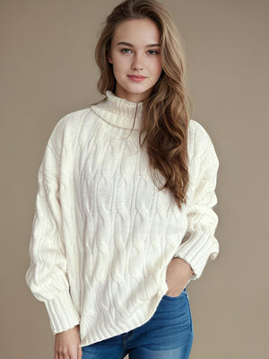 Ivory oversized cable knit turtleneck sweater with a relaxed fit.