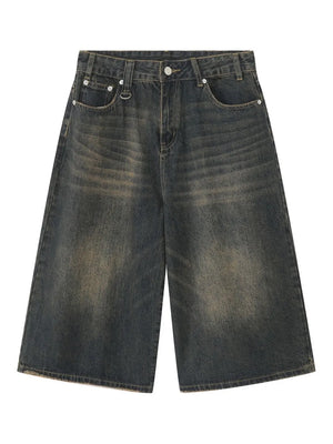 Wide-leg denim culottes in a dark, distressed wash with a raw hem.