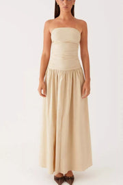 Ruched strapless maxi dress in cream with a flowing skirt and gathered waist detail.