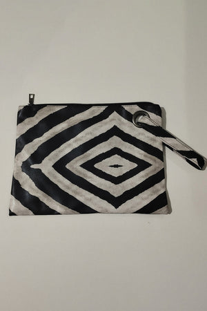 Clutch bag with black and white zebra print, wristlet strap, and grommet detail.