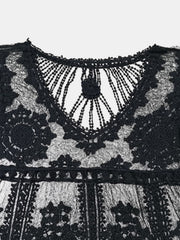 Black embroidered crochet kaftan cover-up with intricate floral details and a V-neckline.