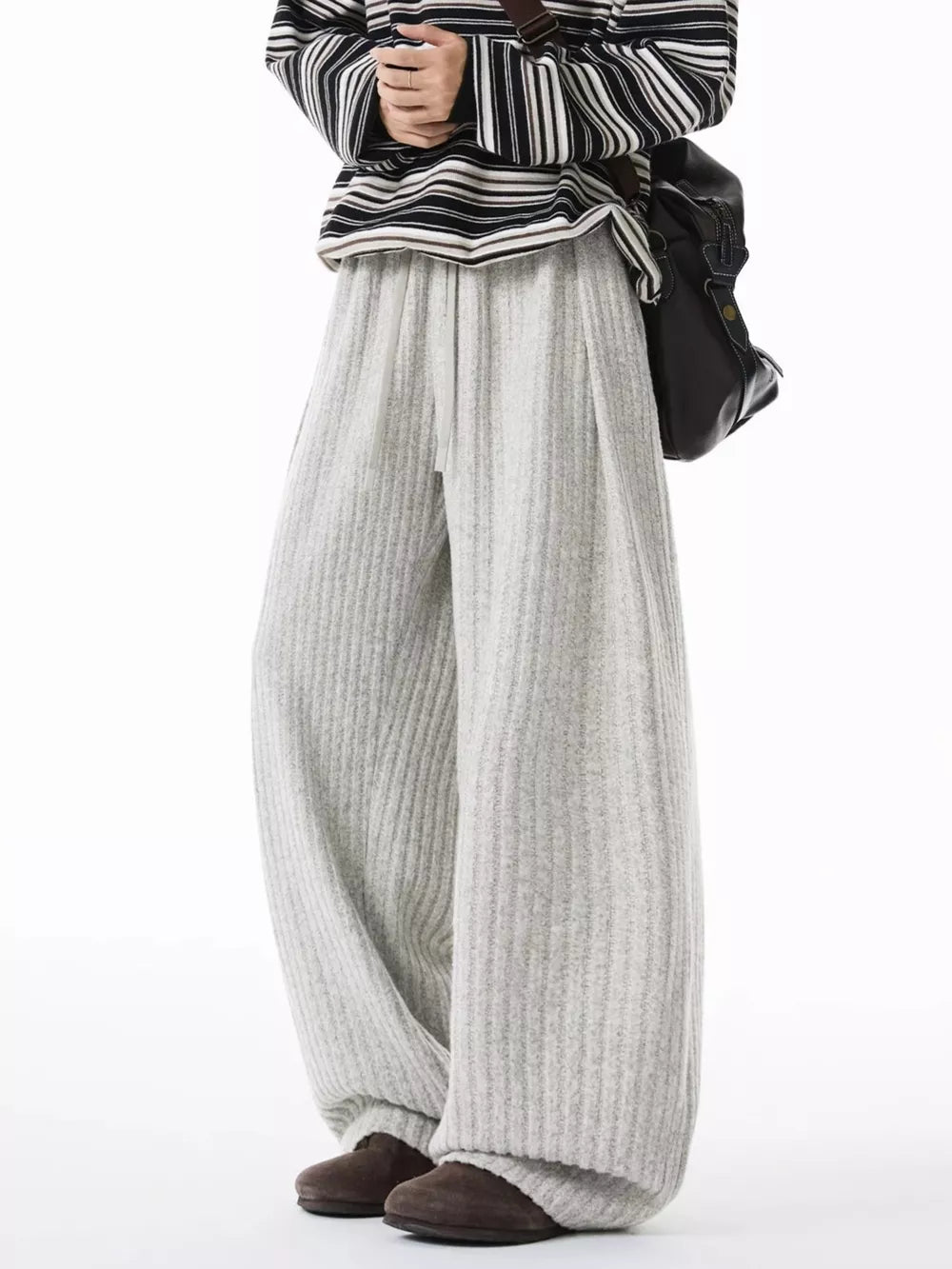 Relaxed ribbed knit sweatpants in light gray with drawstring waist and wide leg.