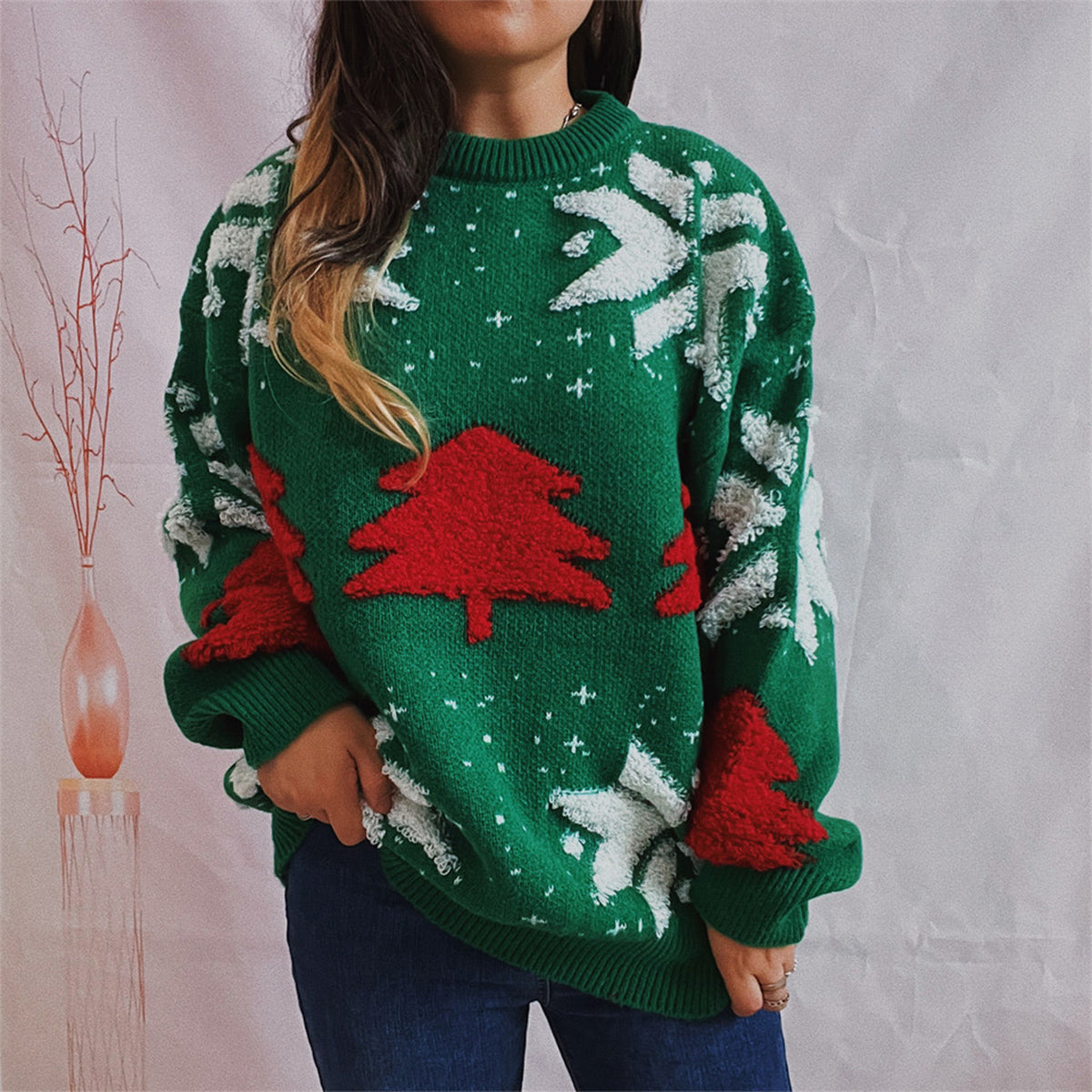 Green acrylic knit sweater with red Christmas tree appliqué and white snowflake details.