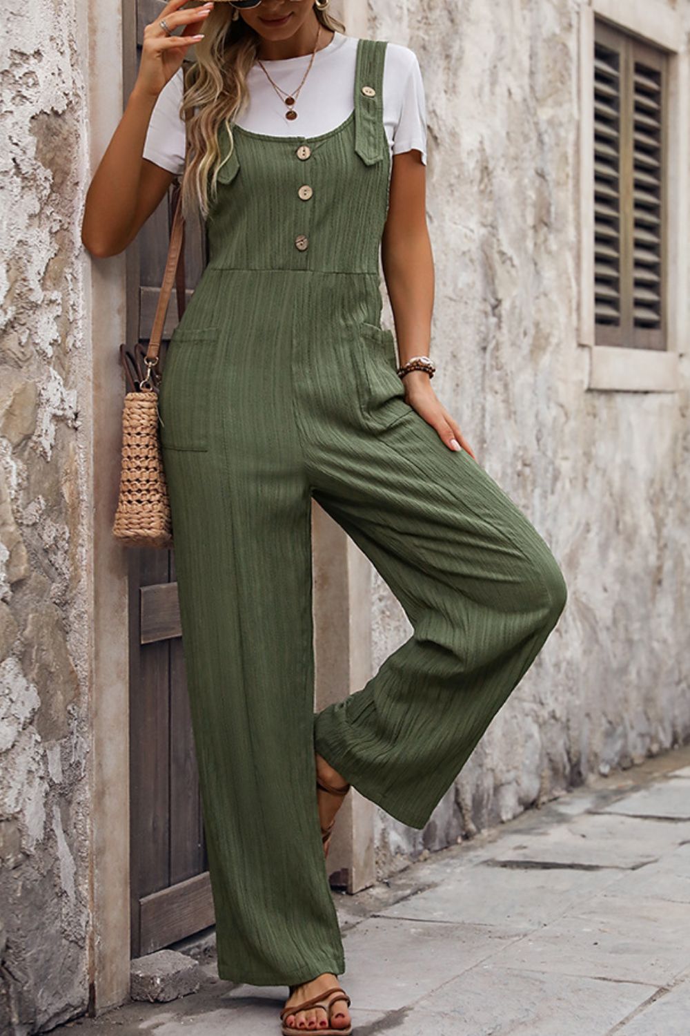 Textured linen button-front jumpsuit in matcha green with wide legs and pockets.