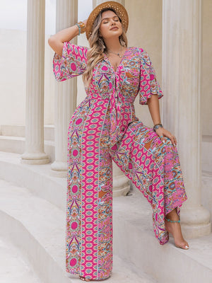Bohemian tie-front palazzo jumpsuit in Deep Rose with bell sleeves and vibrant paisley print.