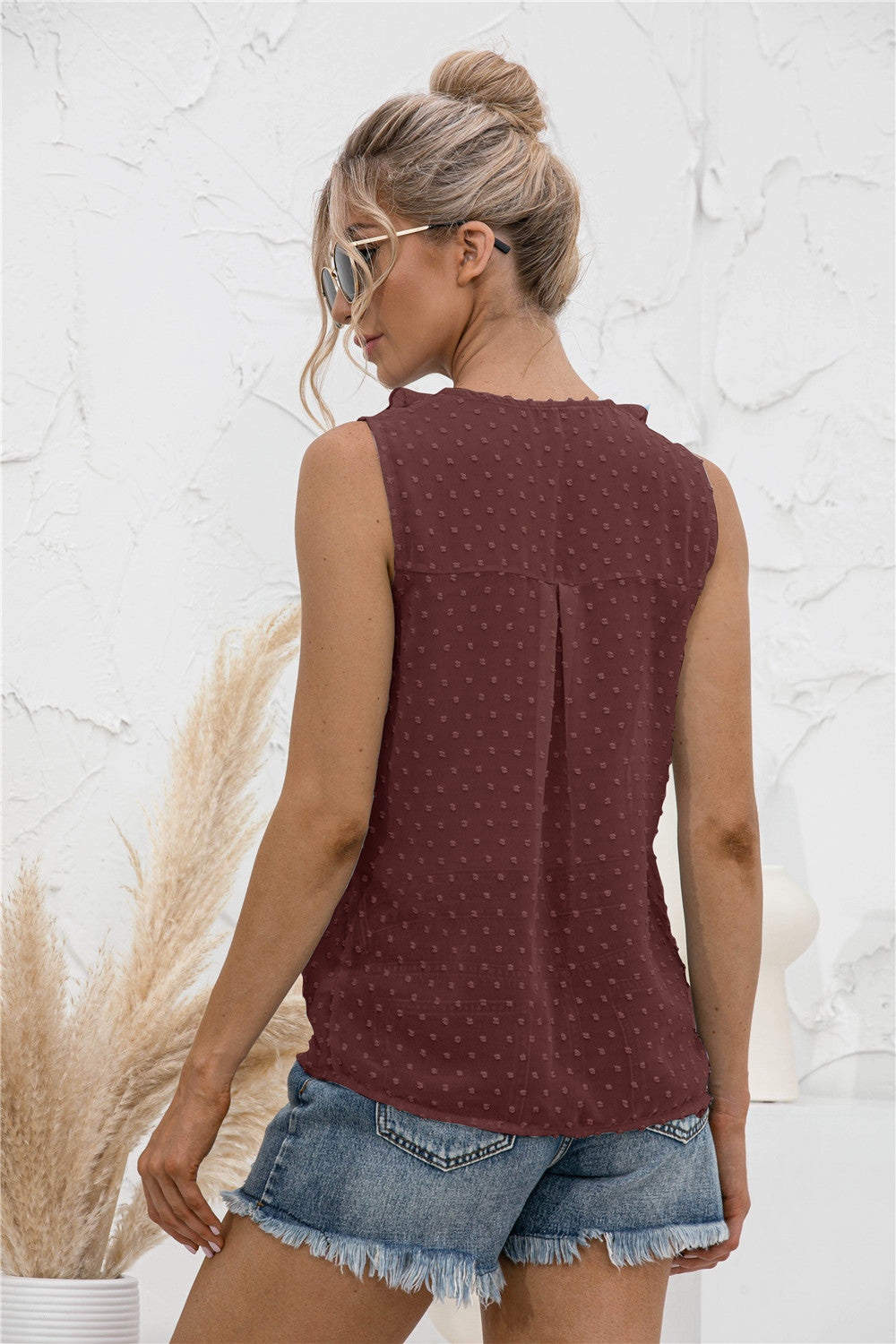 Brown textured ruffle front sleeveless blouse with dotted pattern