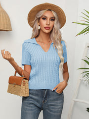 Light blue cable knit polo top with short sleeves and a v-neck collar.
