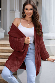 Textured knit cocoon cardigan in maroon with balloon sleeves and open front.