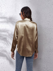 Gold silk button-down shirt with long sleeves and a relaxed fit.
