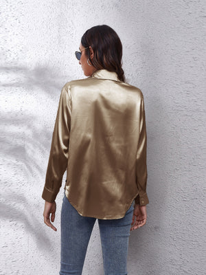 Gold silk button-down shirt with long sleeves and a relaxed fit.