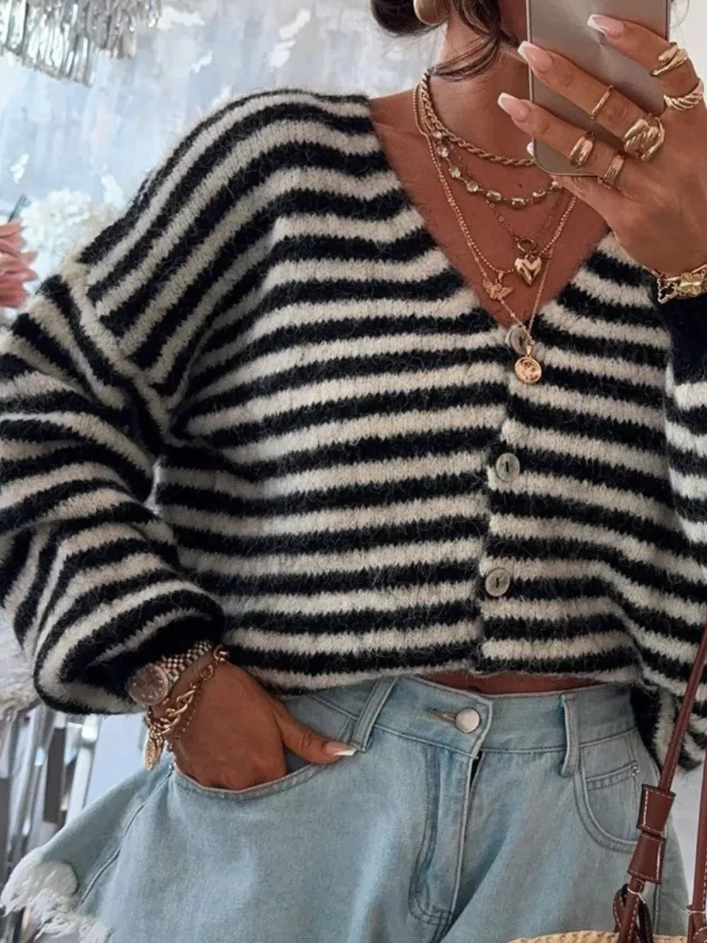 Black and white striped cropped knit cardigan with button front and V-neck.