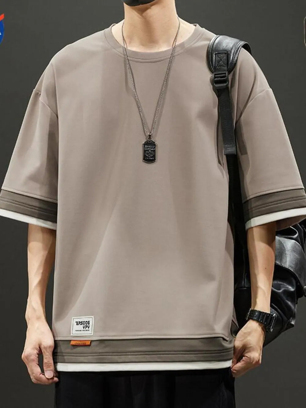 Men's taupe loose fit t-shirt with contrast stitching on sleeves and hem.