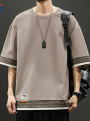 Men's taupe loose fit t-shirt with contrast stitching on sleeves and hem.