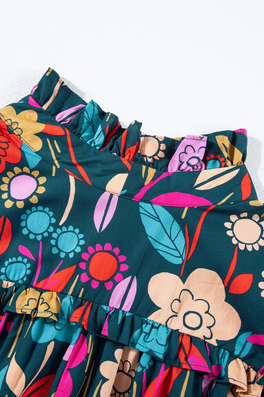Botanical ruffle-sleeve tie-neck blouse in floral print with ruffled neckline detail.